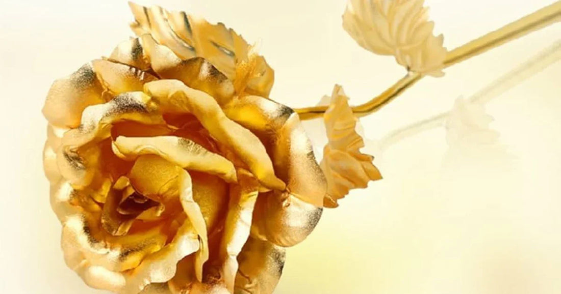 Close-up of a real rose preserved and plated in 24K gold with gold stem and leaves