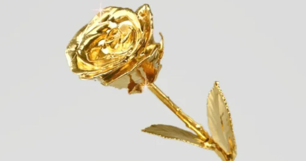 24K gold dipped real rose with detailed petals and leaves on a plain background
