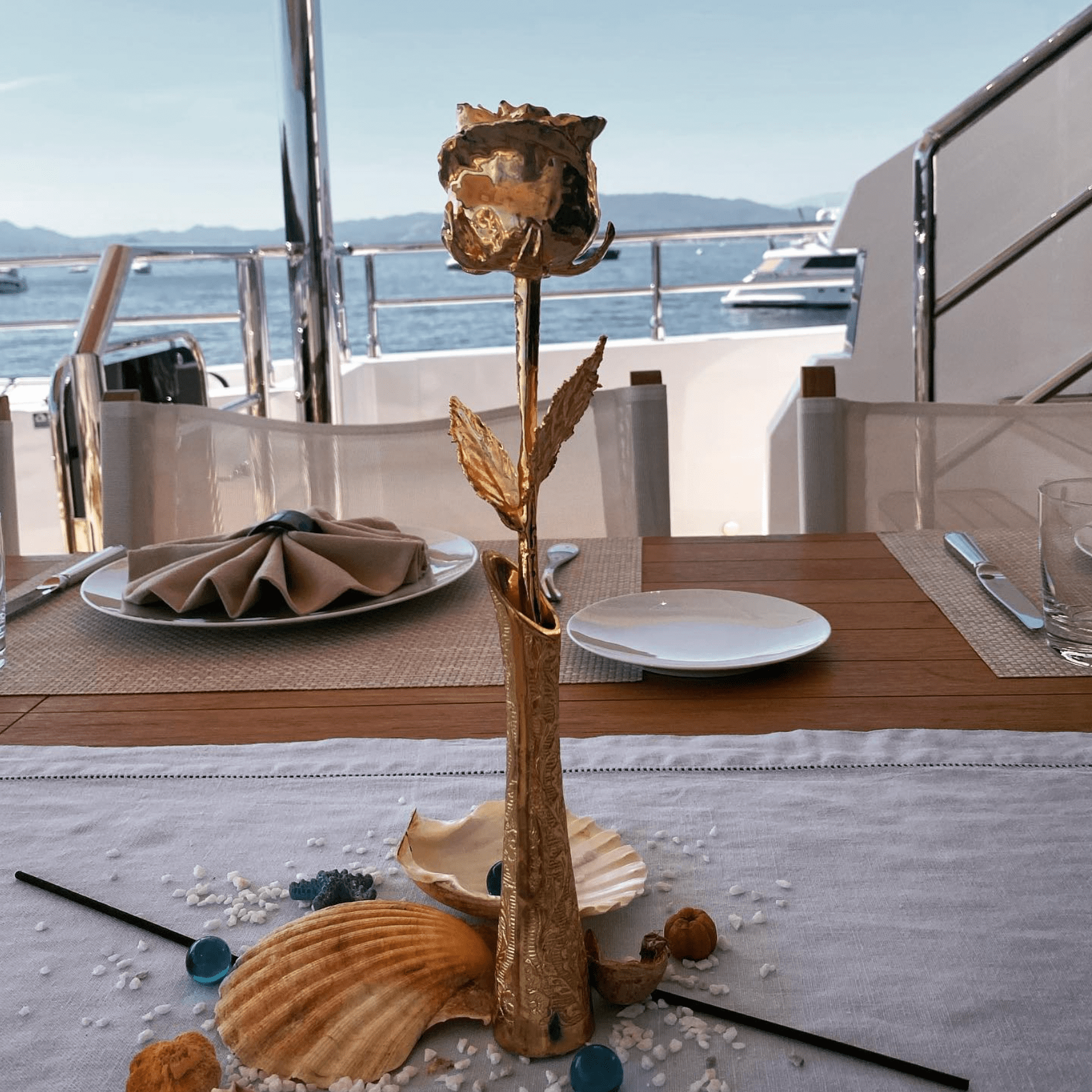 Lovepicker 11.5 inch gold dipped vase for preserved rose displayed on a table with seashell decor
