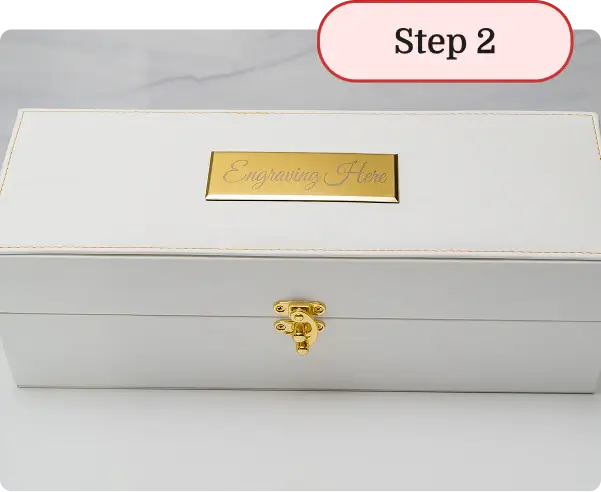 White jewelry box with gold lock and 'Engraving Here' label on a white background