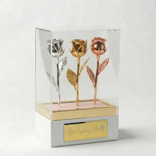 Tricolor preserved roses in silver, gold, and rose gold displayed in an acrylic gift box with customizable plaque.