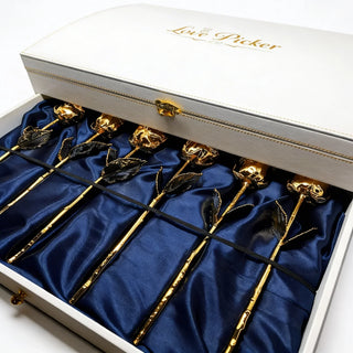 Gift box of gold preserved roses displayed on blue satin lining for luxury gifting