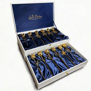 Box of preserved 24K gold roses arranged on blue satin, luxury gift presentation