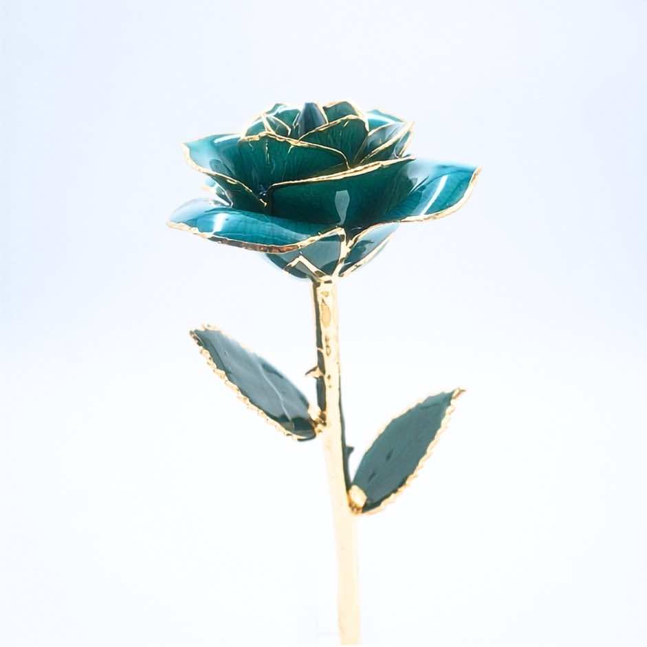 Emerald green open bloom preserved rose with 24K gold accents, angled half-length view
