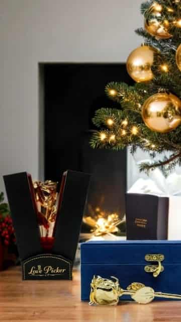 Decorative items including a gold ornament and a black box with 'Love Picker' branding in front of a Christmas tree.