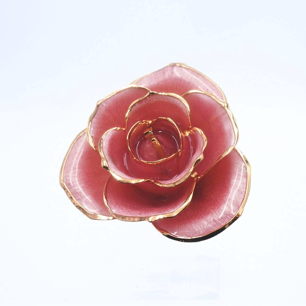 A rose-shaped brooch featuring translucent pink petals with polished gold-tone edges, shown on a plain white background.
