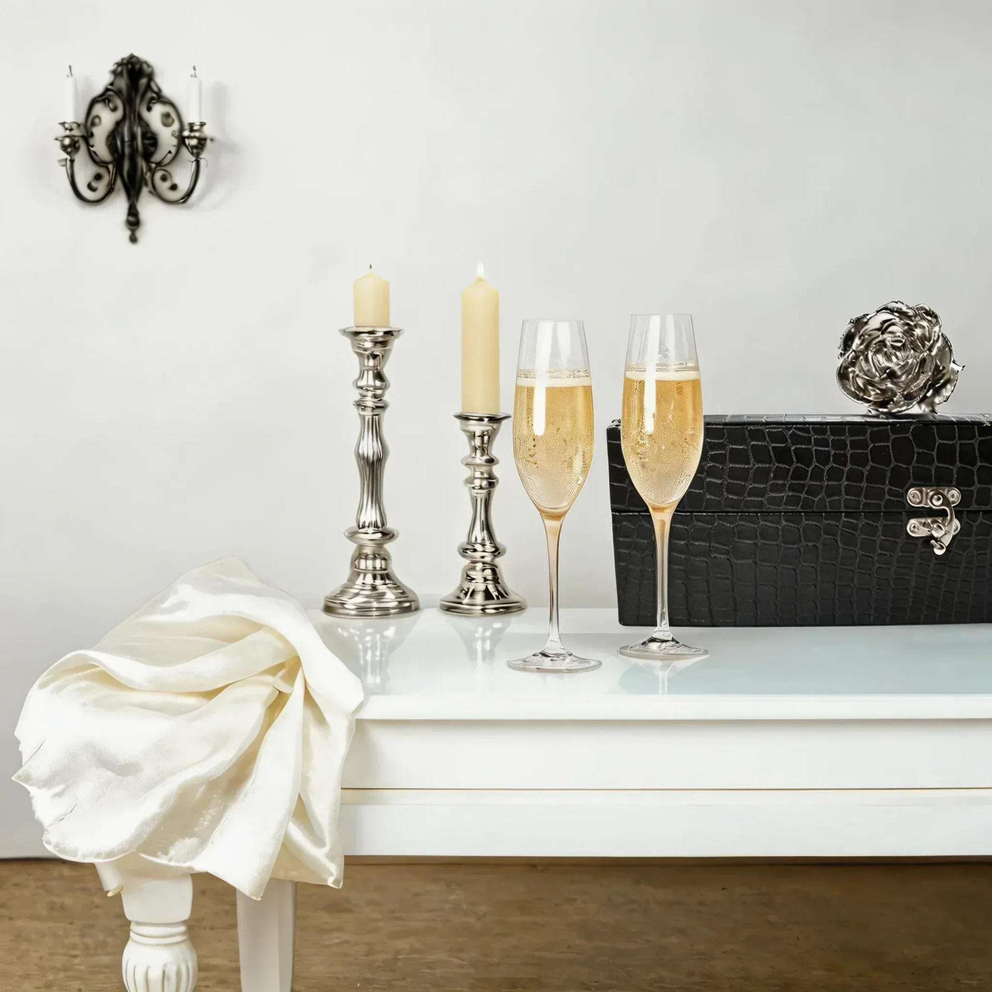 Elegant table with gold preserved rose gift box, candles, and champagne glasses for romantic decor