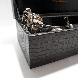 platinum dipped gold rose in a black textured box on a white background