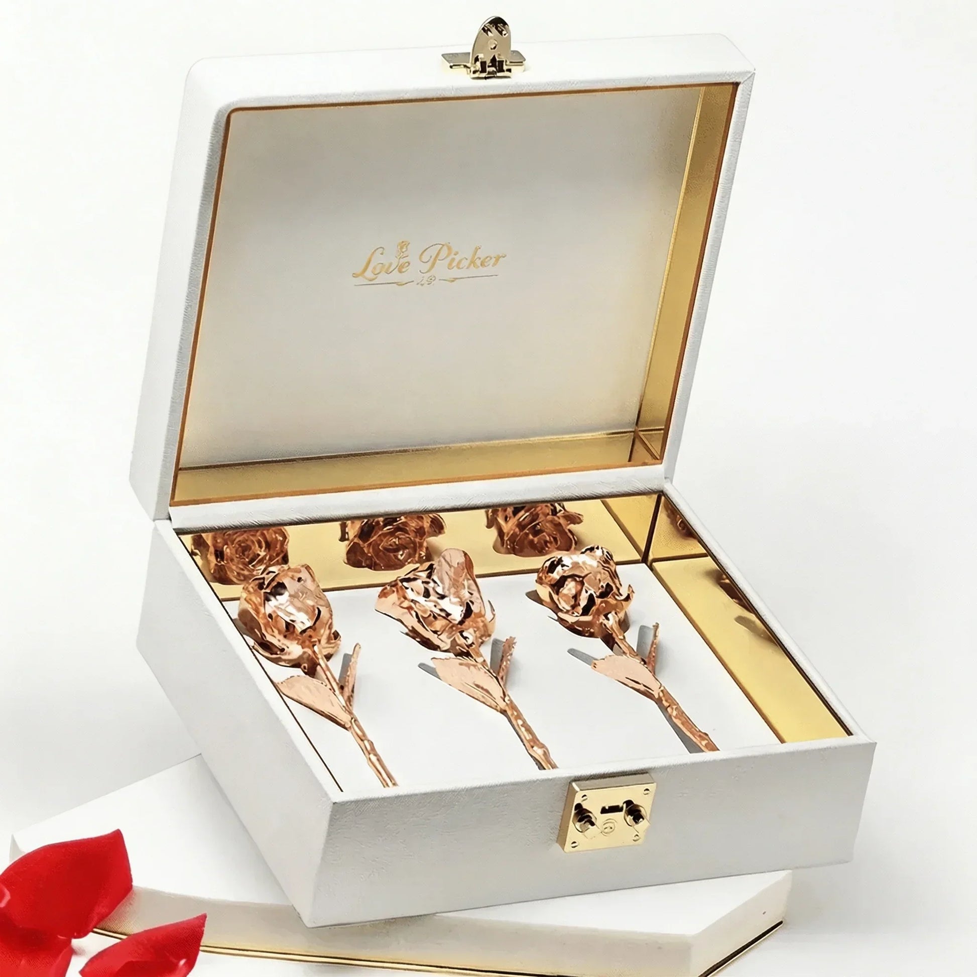 Rose gold preserved roses in a white gift box with gold interior, luxury romantic gift