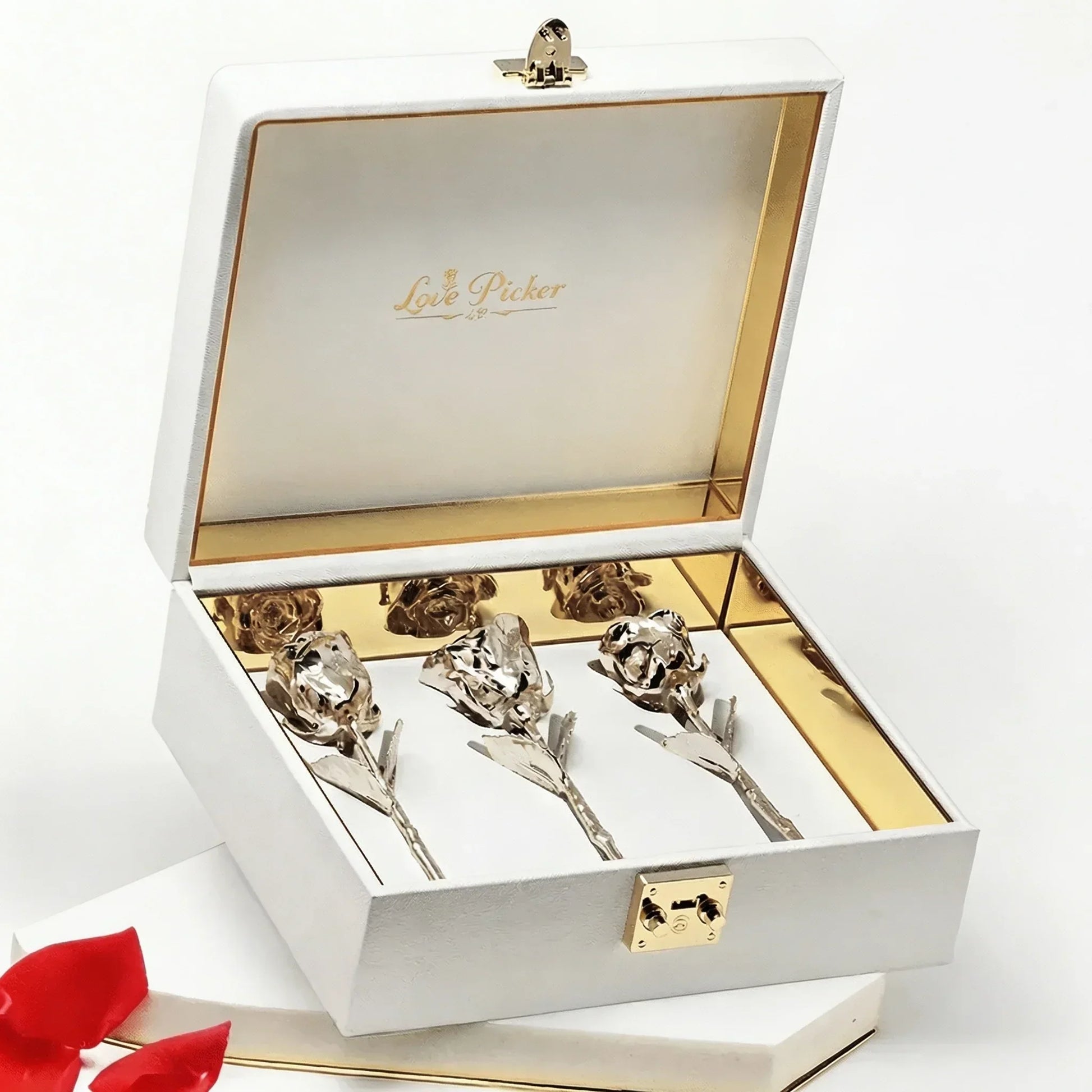 Luxury white box with gold trim containing preserved gold roses, elegant gift presentation