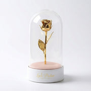 Gold rose inside a glass dome on a white base with 'Love Picker' branding.