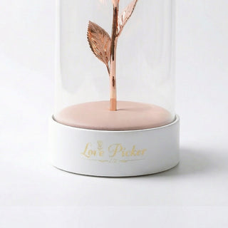 Rose gold leaf in a white cylindrical container with 'Love Pickers' branding on a light background
