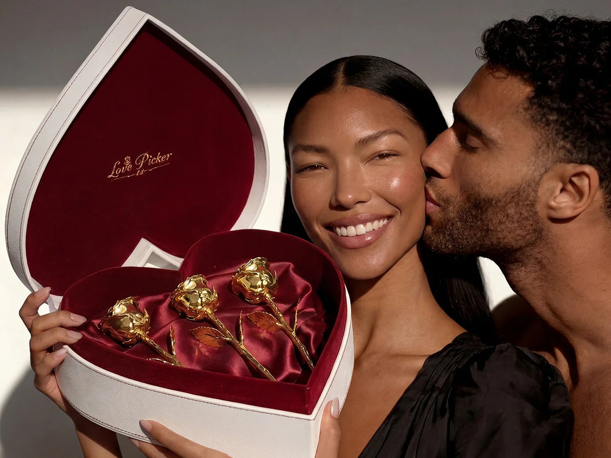Three 24K gold dipped roses in white heart box with red velvet lining, perfect for Valentine’s Day or romantic gifts.