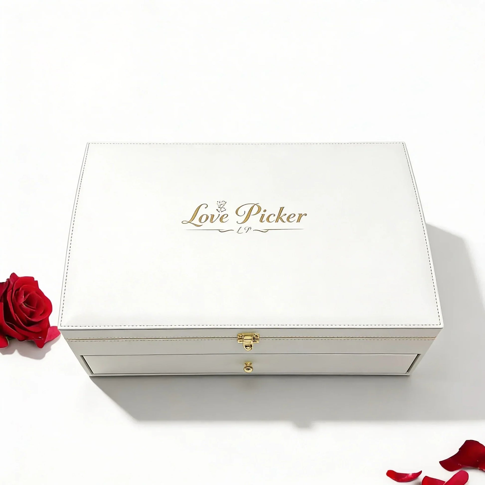 White luxury gift box with gold clasp and logo, surrounded by red rose and petals