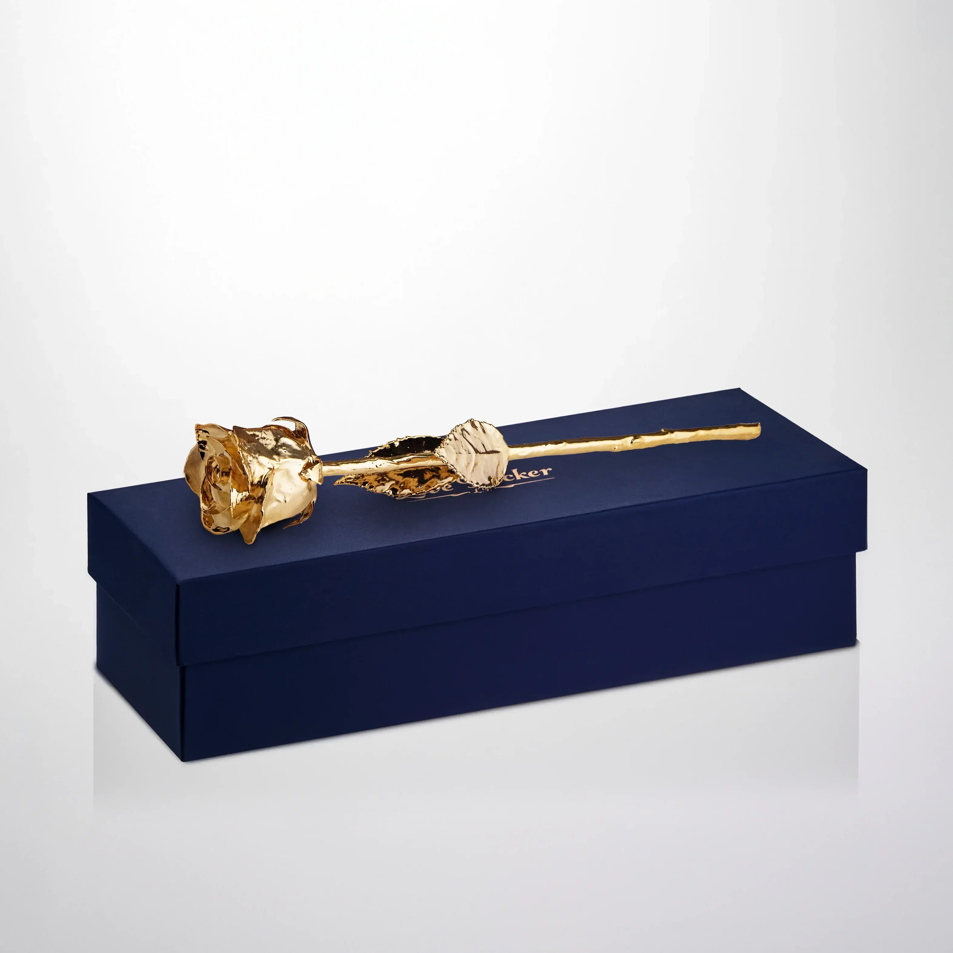 24K gold preserved rose displayed on a navy blue luxury gift box, elegant presentation